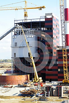 Cranes and chimney on construction site