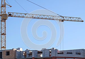 Cranes,construction crane equipment over building construction site on blue sky background on day,technology transportation materi