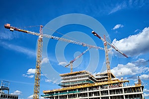 Cranes at the construction site of an office buildingg