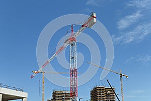 Cranes at costruction site in new urban developing zone