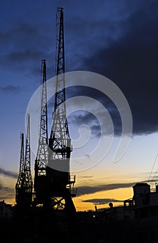 Cranes in The dock at Harbourside area at sunset