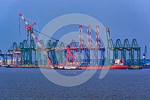 Cranes on dockside of commercial port.