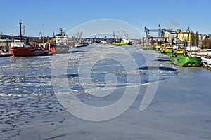 Cranes in the Gdansk shipyard and the frozen river