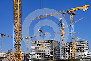 Cranes and machinery new building construction site