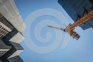 Cranes and scaffolding at a construction site in Bangkok, Thailand