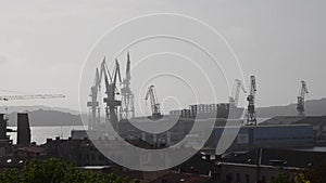 Cranes in Shipyard Uljanik in Pula, Croatia. Harbour at Adriatic sea. Cranes, Jackup rig, Oil platform and Container crane in Dock