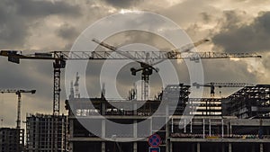 Cranes working day and night on construction of the housing estate in former industrial zone