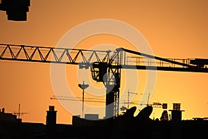 Cranes working at sunset in Lisbon