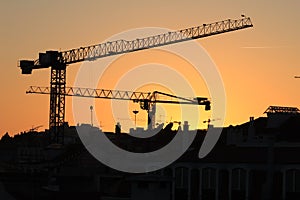 Cranes working at sunset in Lisbon