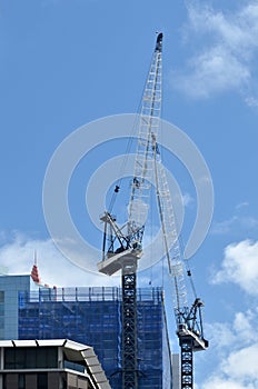 Cranes works in new apartments building block construction site