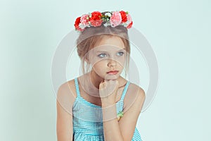 Cranky girl looking at camera with arms crossed, folded hands