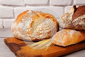 Fresh homemade bread assortment on old cutting board