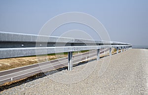 Crash barrier and road