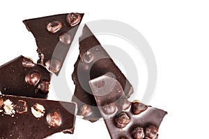 Crashed blach chocolate bar with large hazelnuts