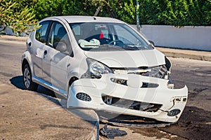 Crashed car after accident with deflated airbags on road in city