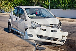 Crashed car after accident with deflated airbags on road in city photo