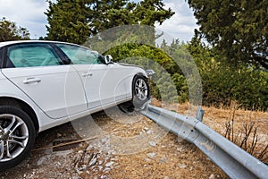 Crashed car with deflated airbags after accident finished on road crashed barrier