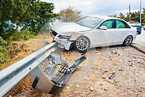 Crashed car with deflated airbags after accident finished on road crashed barrier