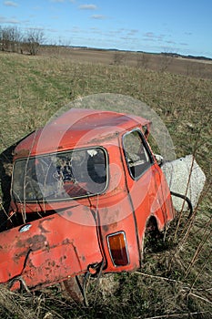 Crashed car in field