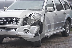 Crashed car on front left in car accident insurance concept