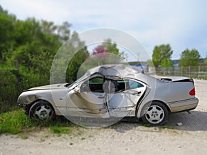 Crashed car. Smashed sheet metal grey bodywork.