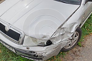 Crashed silver car front fender insurance accident broken collision damage