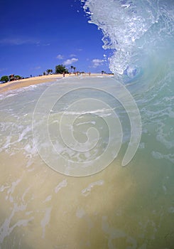 Crashing on a Sandy Beach on Oahu, Hawaii