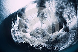 Crashing wave with foam and air bubbles underwater. Transparent sea water