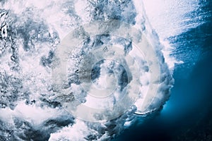 Crashing wave with foam and air bubbles underwater. Transparent sea water