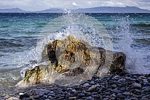 A crashing wave on a volcanic rock creates beautiful splashes!