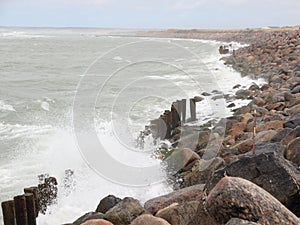 Crashing waves against black rocks at coast