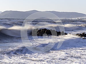 Crashing waves on the beach in massa photo