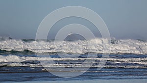 Crashing waves with decommissioned Tillamook Lighthouse along Oregon coast HD