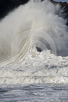 Crashing waves forming a fan shape.