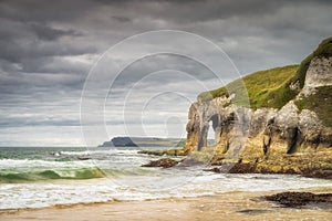 Crashing waves and limestone rock formations on White Rocks Beach, Northern Ireland