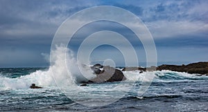 Crashing waves at rocky ocean cliffs