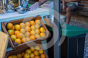 Crate of oranges produce in crate on street corner at grocery store