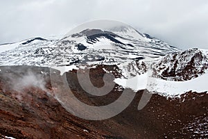 Crater of Mount Etna volcano in winter, Sicily island, Italy. Landscape of Silvestri craters with black volcanic lava