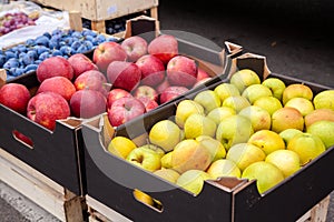Crates of apples at a farmers market.