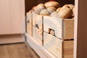 Crates with potatoes on shelf. Orderly storage