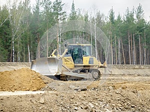 Crawler bulldozer on the construction of the highway