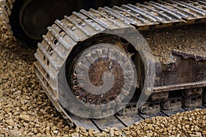 The Crawler close up , muddy crawler chain detail in earthy ambiance, Well used excavator tracks closeup