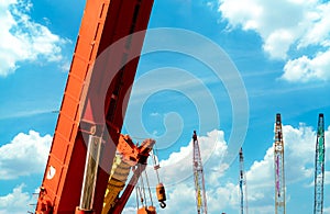 Crawler crane against blue sky and white clouds. Real estate industry. Crawler crane use reel lift up equipment in construction