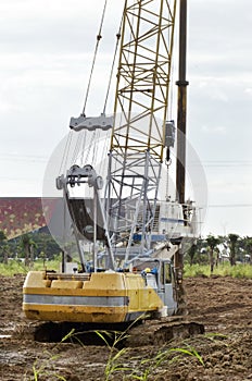 Crawler crane standing alone at construction site