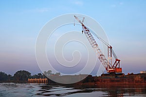 Crawler cranes used for rebuilding bridges  near the river