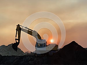 Crawler excavator with a bucket on a sunset background. Tractor for digging in the sun. Excavation equipment in the sand