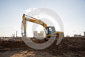 Crawler excavator at a construction site during digging ground for laying sewer pipes. Backhoe on earthworks at construction site