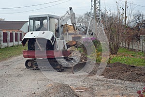 Crawler excavator digging on demolition site. Excavating machine. Earth moving equipment. Excavation vehicle.