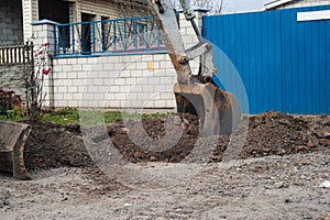 Crawler excavator digging on demolition site. Excavating machine. Earth moving equipment. Excavation vehicle.