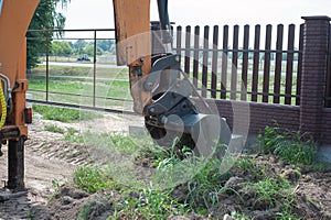 Crawler excavator digging on demolition site. Excavating machine. Earth moving equipment. Excavation vehicle.